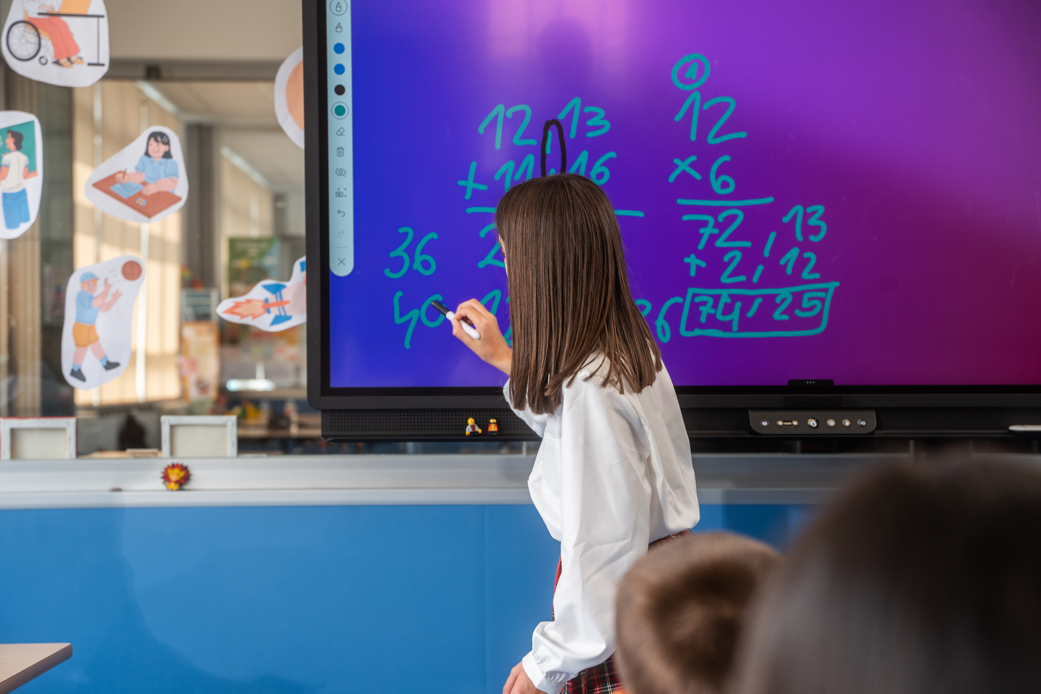 Student Writing on Interactive Board